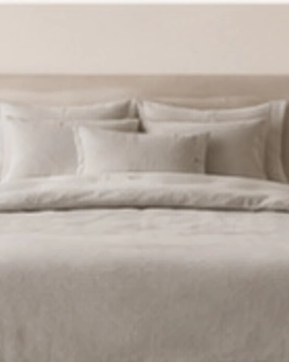 Striped hotel bedding in a calm bedroom
