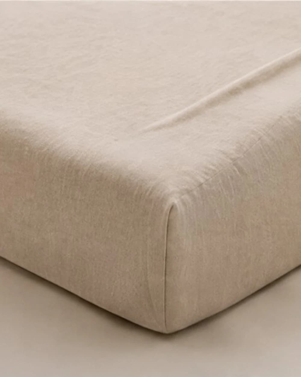 Ivory jersey fitted sheet on a mattress