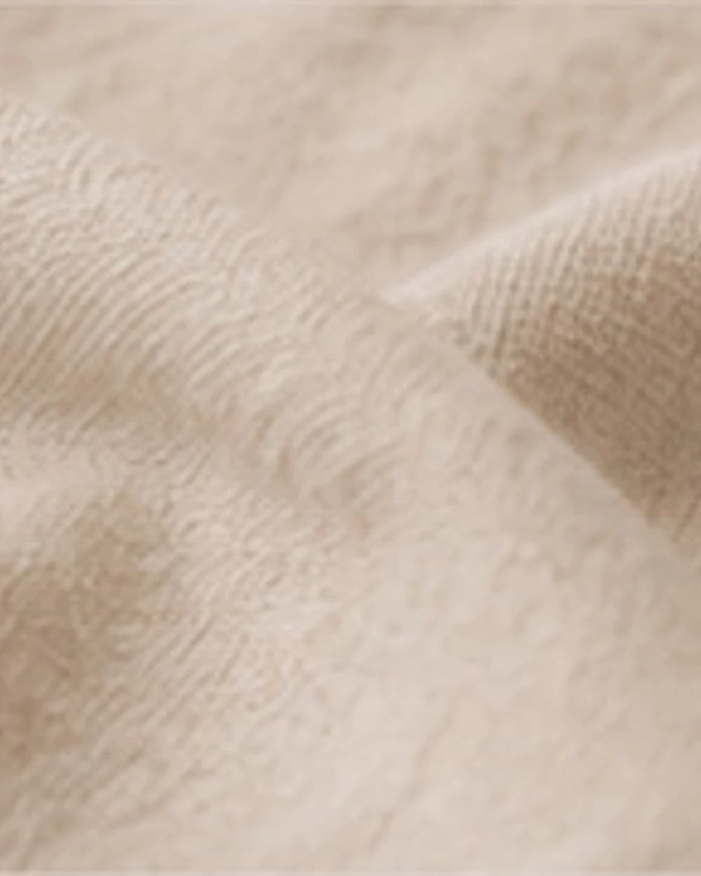 Stonewashed linen throw folded on a sofa